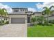 Two-story home showcases a beautiful facade with gray tile roof and landscaping at 5713 Cheech Gln, Lakewood Ranch, FL 34211
