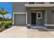 Modern two-story home with gray siding, two car garage and landscaping at 11440 Planetree Pl, Bradenton, FL 34211