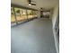 Spacious screened porch with a gray epoxy floor at 20570 Tappan Zee Dr, Port Charlotte, FL 33952