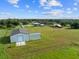 Aerial view of property showcasing home, barns, and expansive land at 23800 Jennings Rd, Myakka City, FL 34251