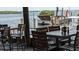 Outdoor seating area overlooking the water with tables and chairs at 3697 Lake Bayshore Dr # H-109, Bradenton, FL 34205