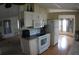 Open kitchen with appliances, cabinetry, and adjacent dining area, seamlessly blending cooking and living spaces at 6064 Shearwater Dr, Englewood, FL 34224