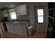 Bright kitchen with white cabinets, sink, and view to the side yard, maximizing space and functionality at 6064 Shearwater Dr, Englewood, FL 34224