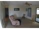 Inviting living room featuring a recliner, rocker, and access to another room through sliding glass doors at 6064 Shearwater Dr, Englewood, FL 34224