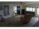 Spacious living room with many windows and a ceiling fan at 6064 Shearwater Dr, Englewood, FL 34224