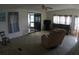 Cozy living room with neutral carpet, ceiling fan, and access to the sunroom for relaxed living at 6064 Shearwater Dr, Englewood, FL 34224