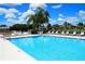 Community pool with lounge chairs and scenic landscaping is perfect for relaxation at 6064 Shearwater Dr, Englewood, FL 34224