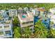 Stunning aerial view of modern home with rooftop pool and lush tropical landscaping at 648 Beach Rd, Sarasota, FL 34242