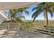 Relaxing balcony with palm tree and beach views at 648 Beach Rd, Sarasota, FL 34242