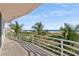 Enjoy a beach view from the balcony with palm trees and blue sky at 648 Beach Rd, Sarasota, FL 34242