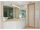 Bathroom vanity with modern lighting, ample storage, and a large mirror at 648 Beach Rd, Sarasota, FL 34242