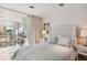 Cozy bedroom with a tufted headboard, serene colors and an adjoining sitting room at 648 Beach Rd, Sarasota, FL 34242