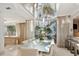 Elegant dining area with a unique chandelier and views of lush greenery at 648 Beach Rd, Sarasota, FL 34242