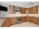 Modern kitchen with stainless steel appliances, stylish wood cabinets, and tiled backsplash at 648 Beach Rd, Sarasota, FL 34242