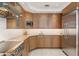 Contemporary kitchen with stainless steel appliances, light wood cabinets and stone countertops at 648 Beach Rd, Sarasota, FL 34242