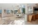 Open-concept living area with dining, kitchen, and ocean views, plus tiled flooring and elegant decor at 648 Beach Rd, Sarasota, FL 34242