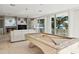 Bright living room featuring a pool table and expansive windows overlooking the beach at 648 Beach Rd, Sarasota, FL 34242