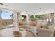Bright living area with cozy seating, large windows and breathtaking ocean views at 648 Beach Rd, Sarasota, FL 34242
