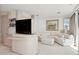Bright living room with comfortable seating, custom shelves, and ocean view window at 648 Beach Rd, Sarasota, FL 34242