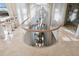 Staircase with glass railing and modern light fixtures, with tiled floors and natural light at 648 Beach Rd, Sarasota, FL 34242