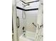 Bright bathroom featuring a shower and grab bars at 906 Tropical Dr, Bradenton, FL 34208