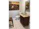 Stylish powder room with glass vessel sink and wood vanity at 906 Tropical Dr, Bradenton, FL 34208