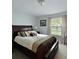Cozy bedroom with a comfortable bed, soft lighting, and a window overlooking the backyard at 906 Tropical Dr, Bradenton, FL 34208