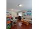 Bonus room featuring light-colored walls, colorful decorations and art, a couch, and natural lighting at 906 Tropical Dr, Bradenton, FL 34208