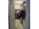 Spacious walk-in closet with custom shelving and ample storage space for clothes, shoes, and accessories at 906 Tropical Dr, Bradenton, FL 34208