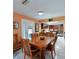 This dining room has a wood table and chairs, and is next to an eat-in kitchen with stainless steel appliances at 906 Tropical Dr, Bradenton, FL 34208