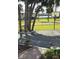 View of the driveway with palm trees, landscaping and basketball hoop in a sunny location at 906 Tropical Dr, Bradenton, FL 34208