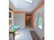 This hallway boasts a colorful decor, white tile floors, a skylight, and an abundance of natural light at 906 Tropical Dr, Bradenton, FL 34208