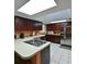 Bright kitchen features dark wood cabinets, stainless steel appliances, and a large island at 906 Tropical Dr, Bradenton, FL 34208