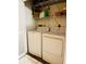Convenient laundry room with modern washer and dryer, plus shelving at 906 Tropical Dr, Bradenton, FL 34208