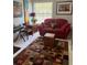 The living room has a piano, sofa and colorful rug at 906 Tropical Dr, Bradenton, FL 34208