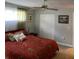 King-size bed, dresser, and ceiling fan in bedroom at 906 Tropical Dr, Bradenton, FL 34208