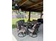 Relaxing covered patio area featuring a dining table with seating for four and a grill at 906 Tropical Dr, Bradenton, FL 34208