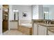 The main bathroom features a soaking tub and double sinks with granite counters at 924 Preservation St, Bradenton, FL 34208