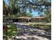 Green house exterior with a carport and landscaped yard at 906 Tropical Dr, Bradenton, FL 34208