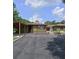 House exterior with a carport and landscaped front yard at 906 Tropical Dr, Bradenton, FL 34208