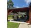 Relaxing covered patio with seating and a hanging table at 906 Tropical Dr, Bradenton, FL 34208