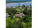 An aerial view showcasing a single-Gathering home's waterfront location at 906 Tropical Dr, Bradenton, FL 34208