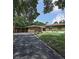 House exterior showcasing a green house with a paved driveway at 906 Tropical Dr, Bradenton, FL 34208