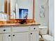 Stylish bathroom with copper vessel sink and onyx countertop at 924 Preservation St, Bradenton, FL 34208