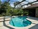 Relaxing kidney-shaped pool and spa with screened enclosure at 22105 Deer Pointe Xing, Bradenton, FL 34202