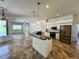 Spacious kitchen with island, stainless steel appliances, and granite countertops at 22105 Deer Pointe Xing, Bradenton, FL 34202