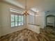 Elegant dining room with chandelier and large windows at 22105 Deer Pointe Xing, Bradenton, FL 34202