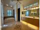 Large bathroom with double vanity, soaking tub, and tile floors at 22105 Deer Pointe Xing, Bradenton, FL 34202