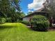 Landscaped side yard with lush green grass and manicured hedges at 22105 Deer Pointe Xing, Bradenton, FL 34202