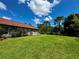 Large backyard with lush green grass and a partially visible home at 22105 Deer Pointe Xing, Bradenton, FL 34202